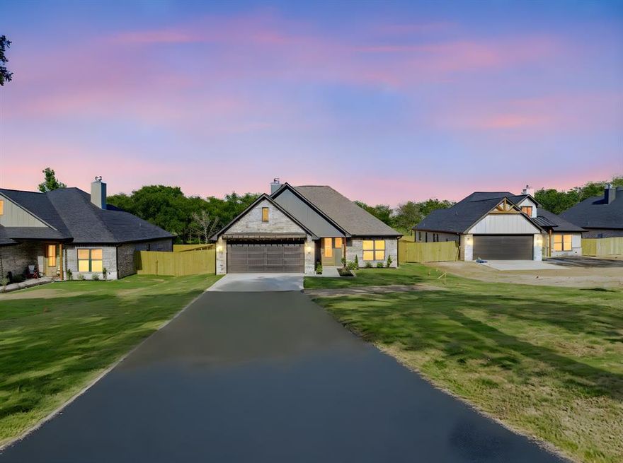 No city taxes, Large lot, Completed in 2025, this single-story 4-bedroom home offers an open-concept layout, engineered hardwood floors, and a fenced backyard on a spacious 0.63-acre lot in Fullingim’s Haven at Mill Run. The living area features a stone wood-burning fireplace with built-ins and opens to a kitchen with custom cabinetry, accent lighting, a large island, upgraded countertops, and stainless appliances including electric range, microwave, dishwasher, and vented hood. The split design places the primary suite on its own side with double vanities, soaking tub, separate shower, and a large walk-in closet, while three secondary bedrooms share a full bath on the opposite wing. Outdoor living includes a covered back porch, fenced backyard, and full sprinkler system. The lot extends well beyond the fenced area, offering additional usable space suitable for a future shop, pool, garden, or expanded outdoor living (buyer to verify). Additional features include central HVAC, ceiling fans, high-speed internet, a 2-car garage, community water, aerobic septic system, builder’s warranty, and no city taxes to help reduce ownership costs. Located approx. 0.5 mi to Athens Middle School with South Athens Elementary, Athens High School, dining, shopping, and medical services all within a short drive. 3D and video tours available online.