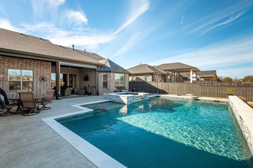 Stunning one-and-a-half-story home situated on a nearly 0.4-acre corner lot with a resort-style pool & spa. A charming front porch welcomes you into a light-filled foyer showcasing beautiful wood floors & soaring ceilings, opening seamlessly to the formal dining room & living area. The living room is both cozy & impressive, featuring wood-beamed ceilings & a floor-to-ceiling stone fireplace flanked by open shelving & lower cabinets—perfect for displaying treasured pieces. The elegant formal dining room offers a built-in hutch, tray ceiling, & crown molding, ideal for hosting gatherings. The kitchen is a standout with crisp white cabinetry, stainless steel appliances, double oven, 5-burner cooktop, & microwave drawer. The oversized island features a deep farmhouse sink & seating for three to four—perfect for casual dining or entertaining. Glass doors lead to a versatile flex space with a walk-in closet, ideal for a home office or additional living area. The private primary suite features a spacious bedroom & luxurious ensuite bath with separate vanities, a large soaking tub, & oversized shower. The walk-in closet includes custom built-in drawers, eliminating the need for a dresser. Two secondary bedrooms downstairs feature wood floors & share a Jack-and-Jill bath with barn-door entrances & a dual-sink vanity. The spacious laundry room has a sink, space for a fridge, & a separate exterior entry for added convenience. Don't forget to check out the large space upstairs that can be a gameroom, second office space, or another bedroom. There is a huge unfinished attic space upstairs too. The oversized epoxy-floored garage offers approximately 912 sf with three individual garage doors. Outdoor living truly shines with a covered patio featuring a motorized screen to block the morning sun. The patio opens to a large backyard with a stunning pool & spa, while a fenced turfed area is an ideal dog run & zero-scape experience next to the pool. Schedule to see this gem today!