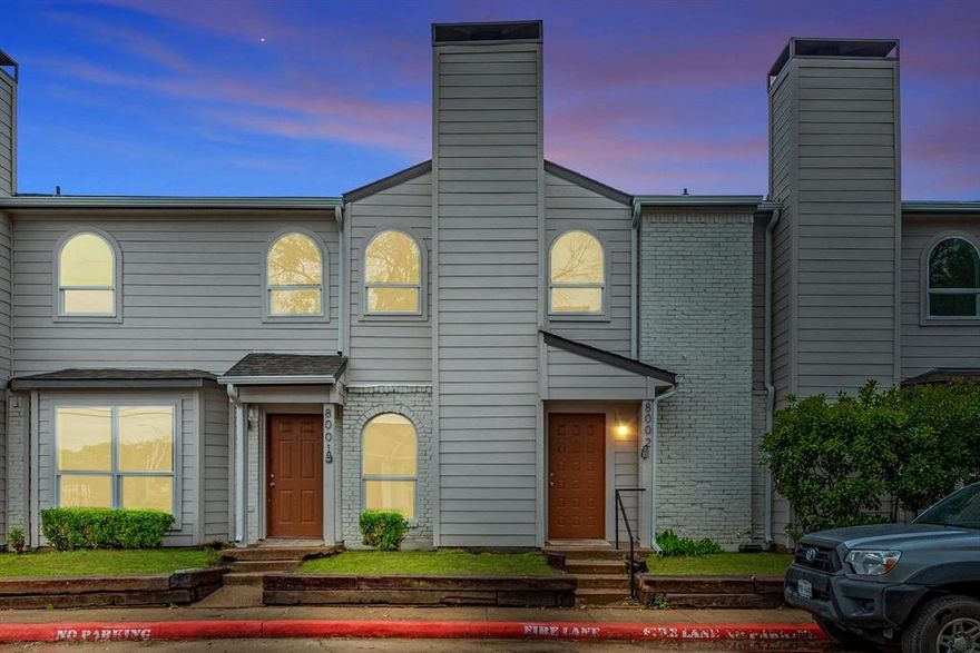 Freshly updated townhome-style condo at 8002 Military Parkway offers move-in ready comfort and great investment potential in Dallas. The light and bright living room features wood-look flooring, neutral paint, a ceiling fan, and a painted brick fireplace, creating a warm gathering space that flows into the dining area and kitchen. The kitchen has been refreshed with white cabinetry, granite-style counters, tile floors, stainless steel appliances, and a convenient pass-through bar for casual dining or entertaining. Upstairs, spacious bedrooms showcase large windows, updated flooring, and generous closet space, connected by a Jack-and-Jill bath with modern vanity, granite countertop, and tiled tub-shower combo. A private fenced patio off the living area provides room for grilling, pets, or outdoor relaxing, while the townhome-style entry gives this condo a single-family feel. Reserved community parking and proximity to major highways, shopping, and schools add everyday convenience. Whether you are an owner-occupant or looking to build your rental portfolio, this updated unit is a smart choice. Investors are welcome, and multiple units in this community are available for sale—ask about package opportunities.