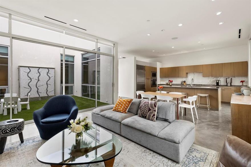 A top-floor luxury residence thoughtfully designed around a striking open-air courtyard and entered by a beautiful, dramatic two-story catwalk. Designed by acclaimed architect Lionel Morrison, this exceptional home is perched among the treetops and unfolds as a light-filled, gallery-like retreat. Floor-to-ceiling windows, skylights, and museum-finish walls soaring over 10 feet create an airy, modern ambiance throughout, while the central open-air courtyard—complete with a tranquil fountain—serves as the architectural heart of the home.

The kitchen is both sculptural and functional, featuring stainless steel countertops, an oversized breakfast island, and premium appliances, including a Sub-Zero refrigerator—perfectly suited for everyday living and effortless entertaining. 
This immaculate property includes two bedrooms, two-and-a-half bathrooms, a glass-enclosed office, a turfed private courtyard, polished concrete floors, a utility room, two garage parking spaces, and a dedicated private storage unit—delivering elevated modern living in one of Dallas’ most architecturally significant boutique communities.

Currently, Units 3B and 3C are adjoined and live as one expansive, seamless home, yet they can be easily reconfigured into two distinct residences.