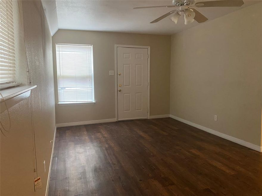 Charming and efficient, this 2-bedroom, 1-bath duplex unit sits in a convenient location with plenty of curb appeal. Enjoy an open living area that flows into a practical galley-style kitchen and a separate utility space, all on easy-to-maintain hard-surface flooring. The home features ceiling fans in the bedrooms and living room for comfort, a refrigerator included, and a front-entry carport with a covered walkway to the front door. Outside, a large, fenced yard with mature trees provides privacy and space to relax or entertain. Proximity to area shopping, dining, and quick freeway access adds everyday convenience