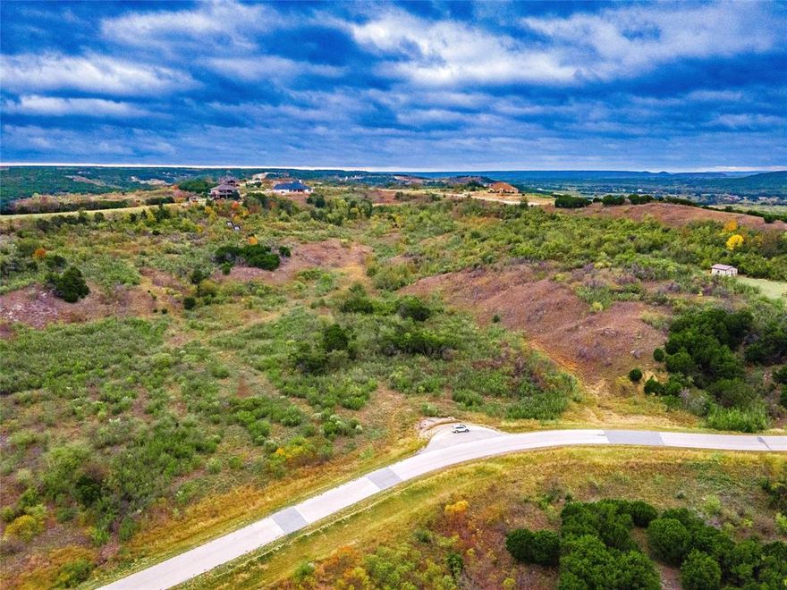 Potential lake views! This 2+ acre lot give both elevation and with a second story home, you could be able to watch where the mighty Brazos spills into and forms the head of Possum Kingdom Lake. Enjoy stunning sunsets, and exquisite views valley views. The Hills Above Possum Kingdom offers parks, fishing ponds, a club house, fitness center, community pool, boat storage, boat launch, courtesy dock, and more. Come check out this beautiful property and make it your own.