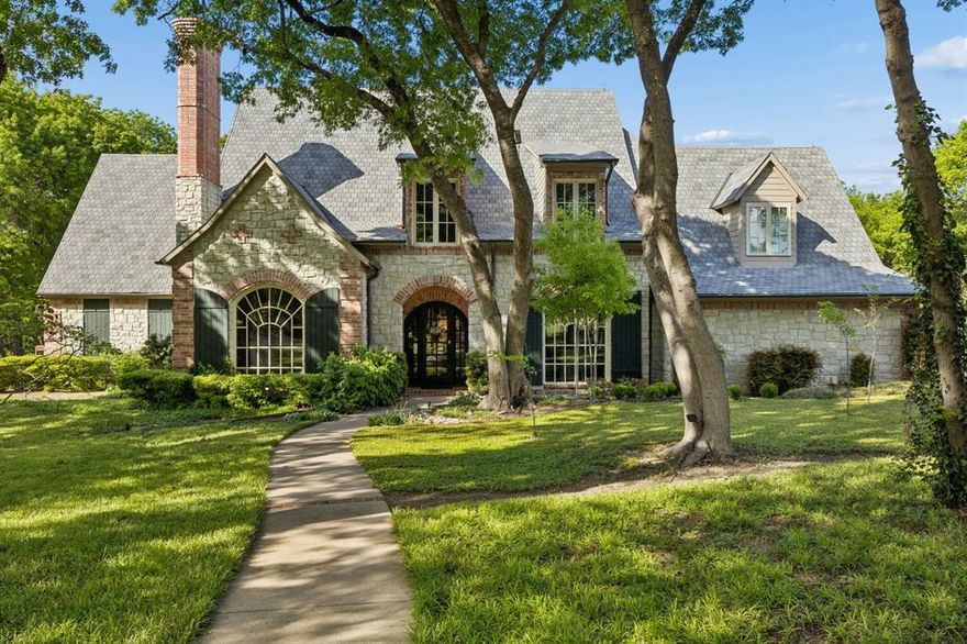 Tucked away on a breathtaking 1.6 acre wooded lot in highly acclaimed LOVEJOY ISD, this iconic Paul Billingsley custom home is one of Fairview’s most recognizable luxury properties. Inspired by timeless French cottage architecture, the home feels as though it was carved directly into the forest, offering unmatched privacy, tranquility, and character while remaining just minutes from premier shopping, dining, and major DFW highways. Designed with exceptional craftsmanship and built on piers for long-term structural integrity, the home showcases brick and stone construction, 8-foot solid core doors, ornamental ceilings, extensive wainscoting and custom moldings, hard wired security cameras, wood encased windows, built-in speakers, class 4 impact resistant roof with lightning prevention system, EV garage charger, high voltage landscape and tree lighting, and so much more. The home has been beautifully updated with recent interior paint, newly installed carpet, and resealed hardwood flooring. The gourmet kitchen features quartz countertops, soft close drawers, a built-in German Liebherr refrigerator, double convection ovens, 6-burner cooktop, ice maker, and outstanding functionality for entertaining. The spacious primary suite offers a massive custom closet plus private gym within the primary bathroom. The floorplan lays out beautifully for guest quarters with private access to east wing of the home, perfect for a variety of living situations. Flex room upstairs could be 6th bedroom if desired. Outdoor living is truly extraordinary. The backyard retreat includes a resort-style pool with waterfall spa and slide, built-in Traeger wood pellet grill with sink, charming fire pit area, extensive landscape lighting, 8x10 storage shed, mature Red Oak trees, abundant yard space, and countless string lights that create a magical camping-like atmosphere at night. The fenced yard includes mesh-backed 3-rail fencing and pet door access. Come visit this exquisite Lovejoy home today!