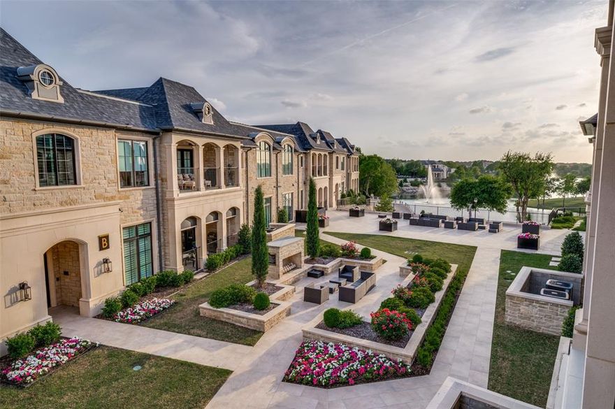 Experience refined, lock-and-leave luxury in the prestigious, gated guarded community of Sur Le Lac in Normandy Estates. Designed by renowned architect Lloyd Lumpkins, this impeccably maintained and gently lived in second-floor residence blends timeless architecture with design-forward interiors. Originally the model residence for the community, the home showcases elevated finishes and thoughtful design throughout. From the moment you enter, the scale and sophistication are unmistakable—soaring ceilings, expansive walls for art, and wide-plank hardwoods set the tone for a home that feels both grand and curated. Bathed in natural light, the open-concept living spaces feel both airy and inviting. The living room is centered around a beautiful ventless fireplace, creating a natural focal point that flows effortlessly into the dining area and chef’s kitchen which offers oversized eat-in island, upgraded appliances, abundant cabinetry, and butler’s pantry for added functionality and storage. A versatile bonus living area off the entry offers flexibility as a home office, formal living or lounge area. The primary suite is a private retreat, complete with floor-to-ceiling windows and a spa-inspired bath showcasing a freestanding soaking tub, oversized walk-in shower, dual vanities, and a custom closet. The guest bedroom offers comfort and privacy with its own ensuite bath and generous closet. Another striking feature of the home is the expansive covered balcony with tranquil courtyard and water views and enhanced with Phantom retractable screens, allowing you to enclose the patio at the touch of a button for true indoor-outdoor living year-round. Balcony is plumbed to accommodate a gas grill, home sound system, elegant powder room, large laundry room, secured underground parking with two spaces, storage unit, elevator access. Amenities including a clubhouse, pool and spa, fitness center, putting green, and beautifully landscaped grounds overlooking serene water features.
