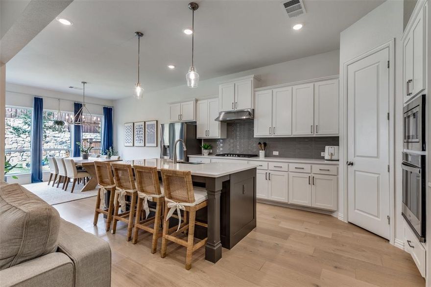 MAJOR PRICE REDUCTION! This beautifully designed one-story home located in the sought-after Reunion Addition features 4 Bedrooms 2 family areas a fireplace and high ceilings throughout. THREE CAR GARAGE. This 2 year old home is located in the SOUGT AFTER NWISD. This floor plan is one of the community’s most popular layouts AND INCLUDES SOLAR PANELS at no cost to the buyer! It also features thoughtful design, upgraded finishes, and exceptional functionality throughout. This home provides ample space for both everyday living and entertaining. The covered outdoor living area extends your entertainment space and is perfect for morning coffee or evening relaxation. Step inside to an inviting open-concept layout anchored by a stunning kitchen with a large island, upgraded cabinetry, quartz countertops, upgraded appliances, and plenty of counter space. The light-filled breakfast nook is wrapped in windows, allowing natural light to pour in. The living areas feature engineered hardwood floors that add warmth and elegance. You will fall in love with the luxurious main suite, offering a generously sized bedroom and a dream walk-in closet with extensive shelving and storage. The secondary bedrooms also include walk-in closets, providing comfort and convenience for family or guests. The private, easy-to-maintain backyard is perfect for peaceful outdoor enjoyment without the upkeep. Residents of Reunion enjoy desirable amenities including a community pool and cabana, walking trails, and a large scenic pond. This home is ideally located just a short distance from DFW Airport and offers quick access to shopping, dining, and entertainment in the Alliance area. This is an exceptional opportunity to own a beautifully upgraded home in a thriving master-planned community. Don’t miss this unique opportunity. Schedule your showing today.