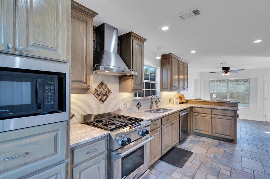 Welcome home to this newly updated retreat on nearly half an acre, where comfort meets sustainability! Located in the highly sought after neighborhood of Silver Ridge with a fishing pond, clubhouse, playground,low HOA fees and the lowest traffic pattern in the entire neighborhood. Enjoy peace of mind with a newer roof, paid-off solar panels, and a freshly painted interior., New Carpet, New LVT, Newly painted cabinetry and banister. Concrete board siding on entire exterior. The spacious layout offers large rooms, a cozy wood-burning fireplace, and a remodeled kitchen with stainless appliances and gas stovetop—perfect for gathering and entertaining. Custom Kitchen Cabinetry leaves no wasted space. Pull out shelving in kitchen cabinets is a convenient upgrade you won't be able to live without! Built in custom cabinet near breakfast area houses media equipment and has a perfect nook to place your wine cooler below. Cabinet under breakfast bar opens from both sides. Full House water filtration system water softener offers crystal clear drinking water. breakfast nook overlooking the backyard with double-gated privacy fence. With thoughtful upgrades throughout, this home blends warmth, character, and modern convenience. Large corner lot with side entry garage offers space from neighbors with wide open field behind in this desirable neighborhood of Silver Ridge. Listing agent is related to seller. All offers will be presented. Garage sale will be held at some point in the near future to empty out garage. Will consider Seller Financing! New pics will be uploaded asap.