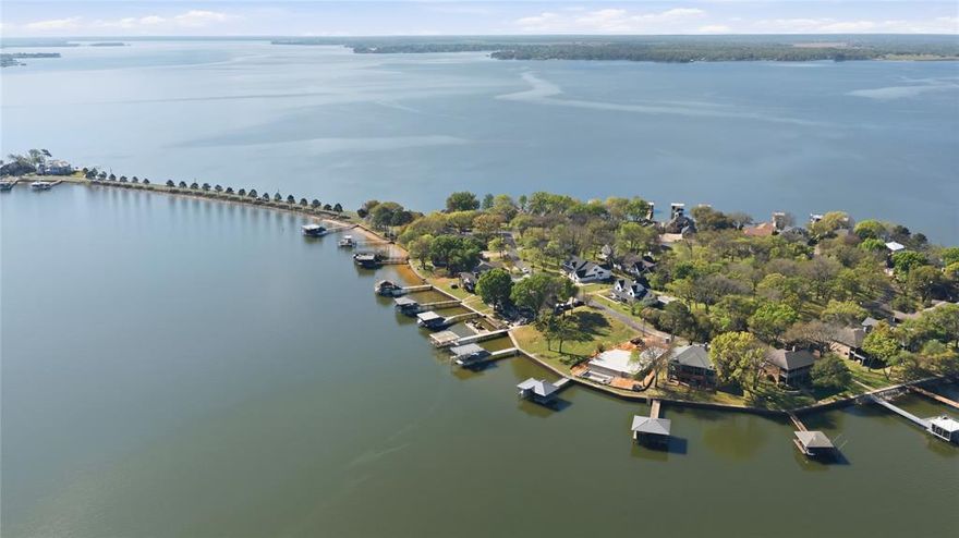 A rare opportunity awaits you in the coveted gated community of Enchanted Isles! This totally updated and remodeled lakefront home features 4 bedrooms and 3 full baths all with breathtaking views and lakeside access from every bedroom and living space. You will especially enjoy your morning coffee in the beautiful morning room off the primary bedroom, which was just completed. The open-concept floor plan, featuring floor-to-ceiling windows and doors facing east toward the lake boasts a gourmet kitchen, with a huge island for cooking and gathering. The family room is especially large to host many friends and family. The outdoor areas include an oversized deck off the family room, a lower-level covered patio, a 5-foot swim spa, and a 2023 boathouse that accommodates a boat and double jet ski lifts. The boathouse is on very deep water because you are on the outermost island. As you enter through the Enchanted Isles gate and drive across the two pine tree-lined causeways, you will know you have found your new ISLAND RETREAT!
