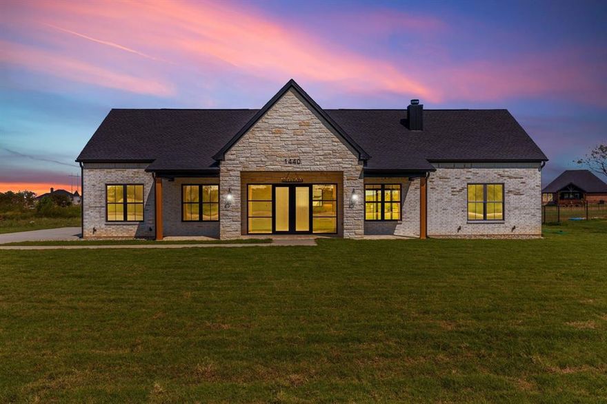 Stunning New Construction on 1 Acre – No HOA! Experience the perfect blend of luxury and country living in this newly built 3-bedroom, 2.5-bath home situated on a spacious 1-acre lot. Thoughtfully designed with soaring 12-foot ceilings throughout, including the garage, this home offers both comfort and style with high-end finishes and energy-efficient features. The chef’s kitchen is a true showstopper, featuring a 10’ x 4’ quartz island, full quartz backsplash, pot filler, vented range hood, and under-upper cabinet lighting—all designed for both function and elegance. A large walk-in pantry with under-cabinet lighting ensures ample storage. Enjoy the seamless flow of natural light through premium black Anderson windows (interior & exterior) and entertain with ease thanks to the black iron & glass sliding patio door and matching iron front door with side glass. The living room and all bedrooms are outfitted with recessed lighting and remote-controlled ceiling fans, with a chic chandelier gracing the front porch. Outside, you'll love the brick-floored patios in front and back, perfect for relaxing or entertaining. The oversized 2-car garage features an 8-foot insulated door, ideal for taller vehicles or extra storage. Built with full foam encapsulation for superior energy efficiency and comfort, and equipped with a heat pump HVAC system, this home is designed to save on energy while keeping you comfortable year-round. All this, with no HOA restrictions, just minutes from the Chisholm Trail Tollway, shopping, and dining—giving you the best of both country charm and city convenience.