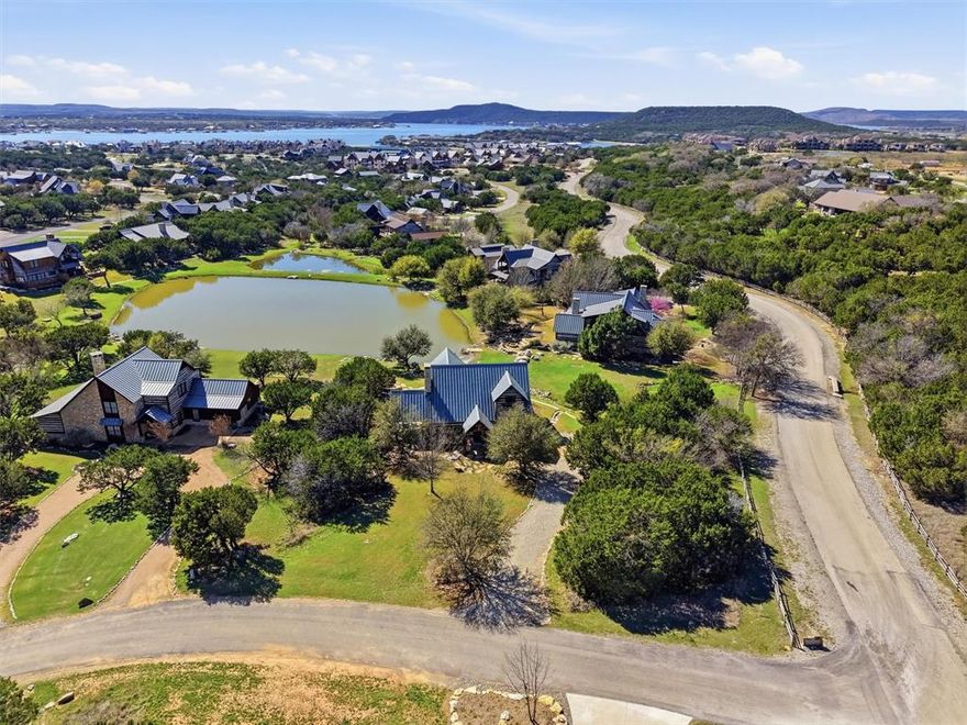 Experience elevated resort-style living in this beautifully furnished luxury cabin, ideally located within the sought-after Harbor community. Overlooking a peaceful stocked pond, this 4-bedroom, 4-bath residence offers an effortless blend of elegance and comfort. The open-concept first floor is designed with entertaining in mind, featuring seamless gathering spaces that invite connection and relaxation. Outdoors, two patios and a striking fireplace create warm, inviting spaces to unwind and take in the tranquil setting. Offered fully furnished, this turnkey property presents a rare opportunity to enjoy a sophisticated retreat in one of the area’s most desirable communities. Harbor amenities include 2 resort pools, fishing ponds, fitness center, sports complex, playground and more!