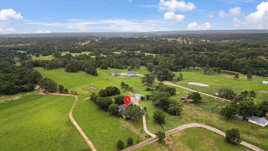 Welcome to your dream farmhouse nestled on just under 2 peaceful acres in the heart of Lindale. This beautifully updated 4,125 sqft home blends timeless charm with modern comfort, offering plenty of room to live, work, and entertain. With 5 spacious bedrooms, 3.5 bathrooms, and 2 inviting living rooms, there’s more than enough space for family gatherings, holidays, or quiet evenings at home. You’ll love the flexibility of a primary suite on both the lower and upper levels, plus a dedicated office downstairs, perfect for working from home or managing a busy household. The large kitchen is a showstopper, combining function with farmhouse flair, complete with a vintage stove that adds a unique touch of class and history. Step outside to enjoy a 30x30 shop with a 20x30 lean-to, ideal for projects, storage, or even a home business setup. If you're looking for the perfect mix of space, character, and country living with room to grow and breathe. This Lindale farmhouse checks every box.