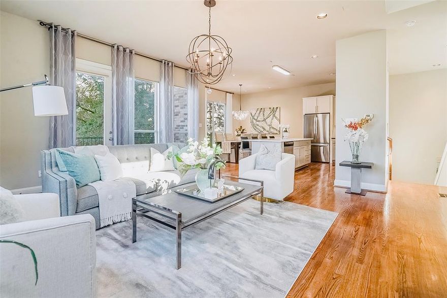 Interior Designer's spacious condo featuring 2 Beds, 3 Baths and 2,023 sq ft in a highly desirable location. Meticulously updated with real hardwood floors (no vinyl plank or carpet) and contemporary finishes throughout. The second floor boasts a large open concept living area with an abundance of natural light, large windows, and high ceilings. A modern chef's kitchen features all stainless steel appliances and quartz countertops on a large island. Upstairs, enjoy the master retreat with an en-suite bath featuring dual vanities and a large shower with a tub. Use the loft as a flex space or a home office. Downstairs, the first floor offers a large second bedroom and full size bath with a door leading to a small fenced back yard. Entertain on the private roof top patio overlooking the downtown skyline or grill on the balcony. Enjoy the outdoors with a quick walk to the Exall park and recreation center! Centrally located minutes away from Downtown, Uptown, Baylor Medical Center, the Arts District, and Lower Greenville. HOA DUES INCLUDE: GAS, WATER, TRASH, FRONT LANSDSCAPING, EXTERIOR INS, AND PEST CONTROL.  All staging furniture is available for sale. This condo is also listed for lease.