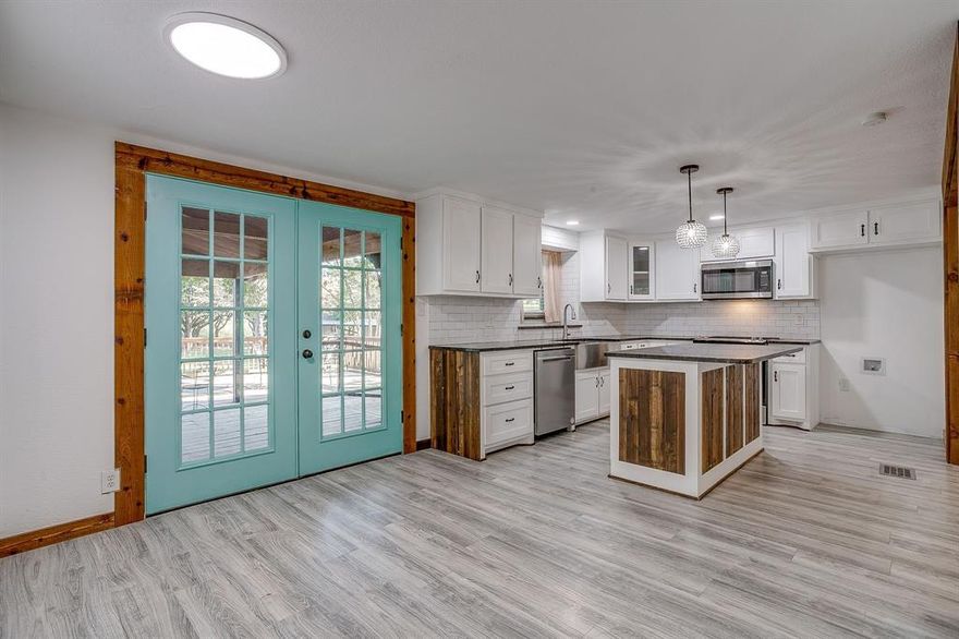 PRICE REDUCTION - THERE IS STILL TIME TO GET INTO THIS HOME IN 2025! This beautifully updated 4-bedroom, 3-bath manufactured home sits on a secluded 1-acre property with mature trees. This home has been meticulously updated with sheetrock walls and a drop ceiling. The 1,578 sq ft home offers a spacious split-bedroom layout, open living area, and completely modernized interior. Enjoy peaceful mornings on the full-length front porch and entertain on the oversized decked patio overlooking the cross-fenced backyard. Property features include two-car carport parking, a metal workshop with electricity and LED lighting, a separate foam-insulated storage building with mini-split, a second insulated unit with LED lighting and mini-split, and a shipping container with power and insulation—perfect for projects, hobbies, or home business needs. An additional dog or pet building adds flexibility for pet loverMini-Split and a washing machine hookup to wash dog blankets. A Tiny Home was moved so there is a separate hook up for a new tiny home with it's own water, sepic system! Power for a RV  or Tiny Home! The property is private, quiet, and move-in ready—this one has it all!