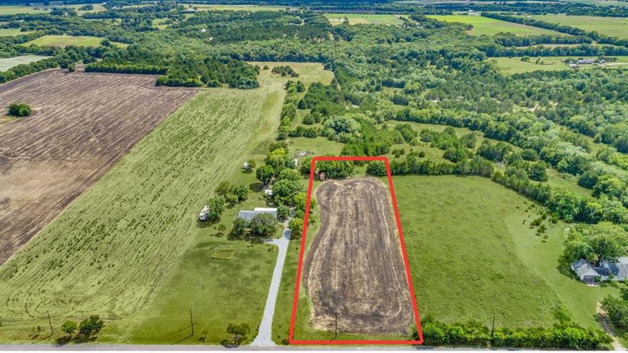 This approximately 1-acre homesite offers a rare opportunity to build a custom single-family residence on a flat, highly usable piece of land with direct road access. Located within the larger 11.084-acre property at 8428 County Road 527, this tract combines privacy, natural beauty, and convenience in one of Anna’s fastest-growing corridors.
The land is level and buildable, making it ideal for a future homesite, workshop, or homestead. A scattering of mature trees lines the rear boundary, creating a natural buffer and offering shade and privacy. Just beyond the tree line sits a beautiful pond, giving buyers the opportunity to enhance the property with their own water feature.
Utilities are available from the road, providing a straightforward path to development. A new survey will be required, allowing the buyer to define the exact 1-acre layout that best suits their vision.