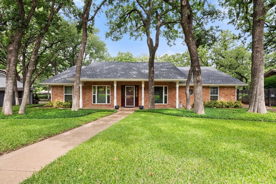 MULTIPLE OFFERS RECEIVED - SELLER ASKING FOR HIGHEST AND BEST BY THURS, MAY 21ST AT 12PM. Beautifully maintained home W timeless character, generous living spaces and thoughtful updates. Flexible, single-story floorplan offers room to gather, entertain and create lasting memories while still providing quiet spaces to relax and unwind. Curb appeal stands out w lush landscaping, towering oak trees and charming front porch. Spacious living and dining areas filled w natural light and updated flooring. Living room showcases vaulted ceilings w beautiful wood beams and classic brick fireplace that creates cozy atmosphere year-round. Kitchen updated w granite countertops, refreshed backsplash, updated cooktop and a functional galley layout that keeps everything within reach while still opening easily to nearby dining and living spaces. Whether preparing weeknight dinners or hosting family gatherings, this home offers balance of charm and functionality. Primary suite provides peaceful retreat w plenty of room for sitting area or workspace; beautifully updated primary bath w dual sinks, granite counters, walk-in closet and modern touches that elevate space. Secondary bedrooms generously sized all offering ensuite bath access; ideal for multigenerational living, guests or growing households. Outside enjoy tranquil backyard setting surrounded by mature trees, established landscaping. Expansive patio and oversized driveway area create endless possibilities for outdoor entertaining, basketball games, weekend gatherings or simply relaxing under the shade w morning coffee. Rear-entry garage, gated driveway add convenience and privacy. Additional update of new roof installed Nov. 2025; offering peace of mind for future homeowners. Conveniently located in heart of Arlington near parks, shopping, dining, entertainment and major highways; home is rare opportunity to move right in while allowing you to gradually make it your own adding personal touches over time. NO CARPET AND NO HOA.