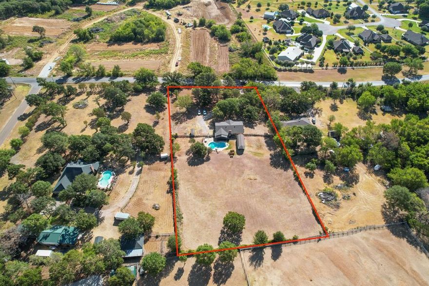 POOL + ACREAGE + NO CITY TAX!! Lovely home located in Burleson ISD with 2.5 acres of land for you to bring your animals or add a garden. You will still have time to make a splash in the Pool!! Also, there is a HUGE storage building in the back which has plenty of space for your extra items, lawn equipment and workshop tools. Backyard has a covered patio which is great for enjoying morning coffee. Front of home features towering trees and gravel drive. Big ticket items already taken care of for you!! Roof just installed installed in July 2022 along with fresh paint on exterior, Main AC and Mini Split also installed at end of July 2022 and flooring in master. The garage was converted to an additional living space and flex space that is currently being used for a massive pantry for tons of storage. Kitchen and dining are open to main living and is great space for entertaining. All bedrooms are a good size with lots of natural light. Great location and with easy access to FM 917 and I-35W.