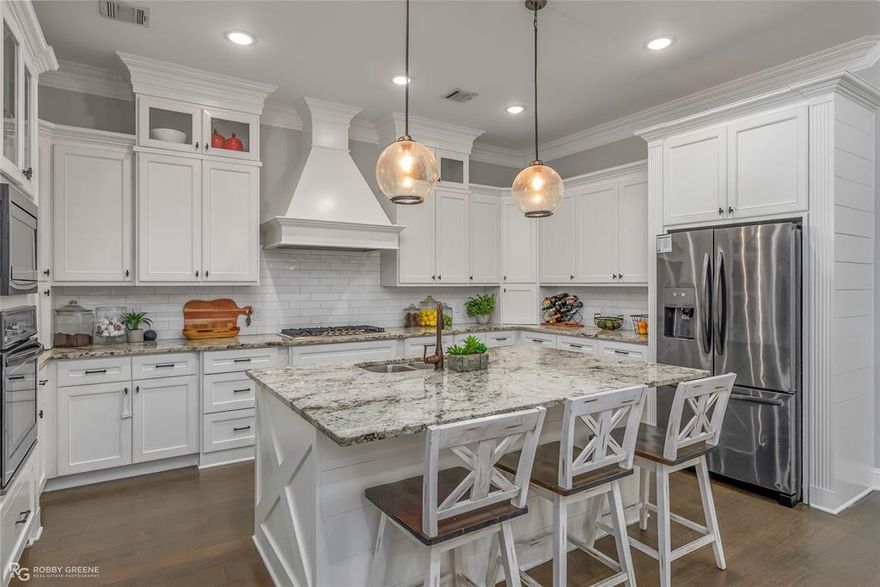 Stunning Shreveport home where Space, Style, and Comfort Await! Discover unparalleled comfort in this beautiful 4-bedroom, 4-bathroom home, with bonus room used as an office, gym, or 5th bedroom. Nestled in a sought after gated neighborhood, with access to a private lake, this residence offers the perfect balance of luxury and functionality. Step inside to a seamless blend of sophisticated design and modern amenities. The heart of this home is the expansive kitchen, a chef’s delight featuring a large island, custom cabinetry, stainless steel appliances, and elegant granite countertops complemented by a tasteful tile backsplash. The open-concept layout integrates the kitchen with the living and dining areas, allowing for effortless entertaining. Seating for four at the island and ample space for a large dining table make gatherings a breeze. The living room is a masterpiece of comfort, showcasing custom built-ins and a cozy gas fireplace. On the first floor, find four spacious bedrooms and three full bathrooms, including a stunning primary suite. This secluded retreat offers wood floors, custom paneling, and a raised ceiling. The adjoining primary bathroom is a spa-like sanctuary with double sinks, a large tiled walk-in shower, a luxurious tub, and an impressive walk-in closet. Guest bedrooms feature abundant space and storage, ensuring supreme comfort. Venture upstairs to discover a versatile space perfect as an office, guest suite, or exercise room, complete with its own full bathroom. The home extends outdoors to a covered patio with an outdoor fireplace, ideal for year-round enjoyment. The fully fenced yard is well-suited for relaxing afternoons, and convenience is ensured with features like a sprinkler system and well-maintained gutters. This extraordinary property promises a lifestyle of relaxation and sophistication, with all the modern touches and space to accommodate your dynamic life. Make this remarkable Shreveport home yours to treasure.