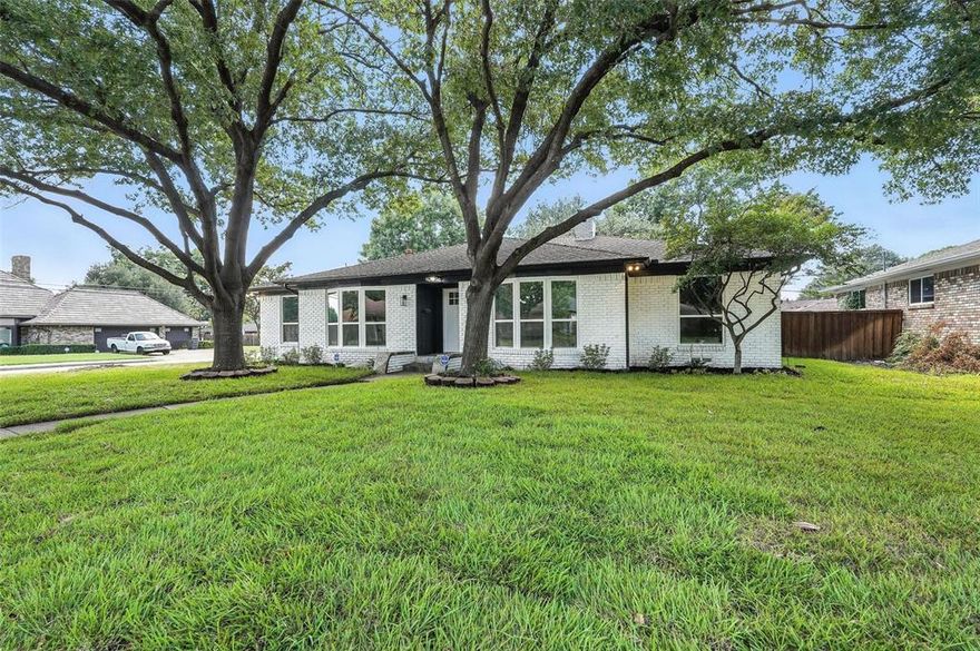Welcome to this beautifully renovated single-story home offering a perfect blend of modern elegance and timeless comfort. Situated on a serene tree-lined street in East Dallas, this 4-bedroom, 3-bathroom residence boasts an open-concept layout with designer finishes throughout.

Step inside to a spacious living area anchored by a sleek floor-to-ceiling fireplace, flowing seamlessly into the dining space and gourmet kitchen. The chef’s kitchen features quartz countertops, custom white shaker cabinetry, stainless steel appliances, and a large island with seating—ideal for both cooking and entertaining.

Retreat to the luxurious primary suite, complete with a spa-like bathroom featuring a freestanding soaking tub, oversized walk-in shower, dual vanities with quartz counters, and gold-accent fixtures. Additional bedrooms are generously sized and share beautifully updated baths with modern tilework and designer lighting.

Enjoy the private backyard shaded by mature trees—perfect for outdoor gatherings, gardening, or simply relaxing. The home also offers a two-car garage, updated systems, and energy-efficient windows for year-round comfort.

Located minutes from White Rock Lake, the Dallas Arboretum, shopping, dining, and top-rated schools, this home delivers both style and convenience.
