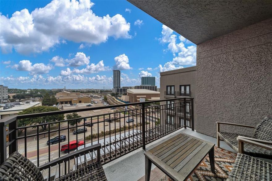 Premium top floor condo with amazing finishes.  Perfect location with view of downtown from master, LR and balcony.  Both bedrooms include WIC.  Accents include brick and faux wood walls, designer wall treatments, patterned bathroom flooring and beautiful light fixtures.  Unit includes 2 parking spaces, washer and dryer. Amenities include outdoor lounge, fitness center and turfed pet area.