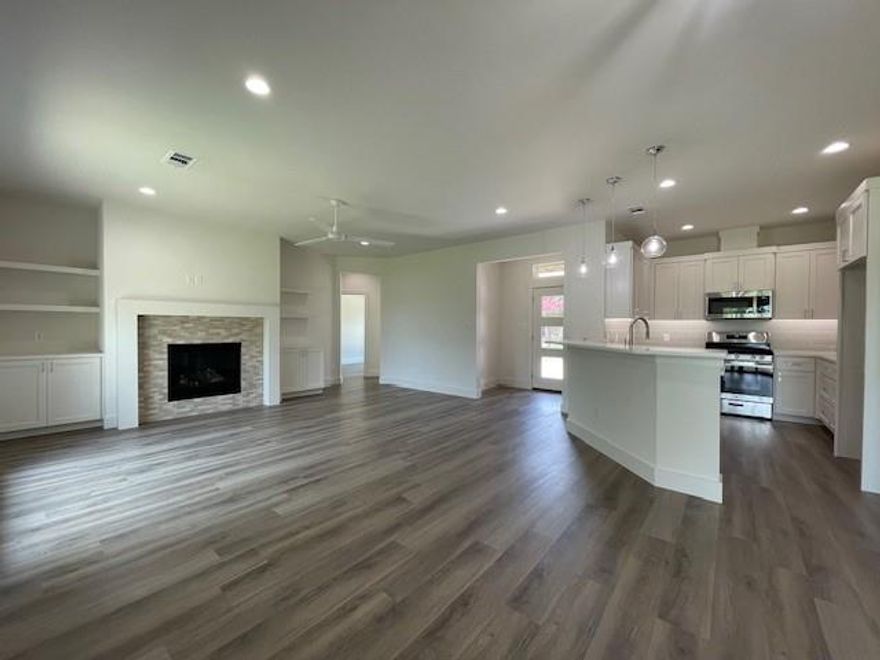 Discover timeless charm and modern functionality in this beautifully crafted 3-bedroom, 2-bathroom fully bricked custom new home, offering 1,649 sq. ft. of thoughtfully designed living space in a quiet, well-established neighborhood.

Built with quality and comfort in mind, this home features an open-concept floor-plan ideal for both everyday living and entertaining. The spacious living area centers around a cozy fireplace and flows seamlessly into a designer kitchen, complete with custom-built cabinetry, elegant quartz countertops, a large farmhouse sink, and a breakfast bar perfect for casual meals or gathering with guests.

Retreat to the private master suite, a peaceful sanctuary offering dual walk-in closets and a spa-inspired en-suite bathroom featuring his-and-her vanities, separate shower and a Hollywood soaking tub, designed to melt the stress of the day away.

Two additional bedrooms share a well-appointed secondary bathroom with dual sinks, ideal for family living or accommodating guests with ease.

Energy efficiency meets convenience with encapsulated foam insulation providing year-round comfort. The large utility room is a dream featuring built-in cabinets, counter space, a hanging bar, and large utility sink. Stay organized with a built-in workstation, charging center with a desk—perfect for a small office nook or command center.

Step outside to enjoy the home's nicely sized backyard, perfect for play, gardening, or entertaining. A covered back patio offers the ideal setting for outdoor dining or relaxing in the shade, while the welcoming front porch adds charming curb appeal. 

Complete with a spacious attached two-car garage, this home combines quality craftsmanship, smart design, and lifestyle-enhancing details at every turn.