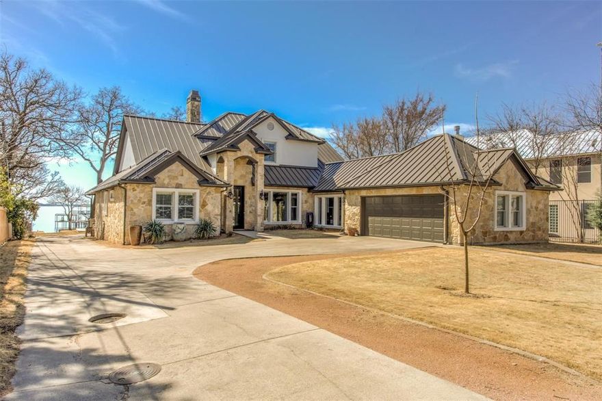 Don't miss this Lakefront home, with acreage on main body of water on Eagle Mountain Lake, in north Fort Worth. From the main street, a quarter mile private road takes you to your own private Oasis! Not only a spectacular main home, this property also has a 1200sf full guest home on premises, 2023 built 2 bedroom 2 bath, kitchen, living and utility. Open floorplan with the most amazing chef's kitchen that has it ALL! HUGE island, built in fridge & freezer, pot filler, double ovens, convection cooktop, warming drawer. An entertainer's dream home, brings the outdoors inside with roll up doors on the climate controlled patio attached. Lifetime memories to be made with sunsets that will take your breath away. 2 story dock with boat slip and jetski lifts. Putting greens out front, sport court, batting cage, and your own private boat ramp! Hand scraped wood flooring., Primary bedroom ensuite on main floor, as well as another bedroom ensuite. Come see today!
