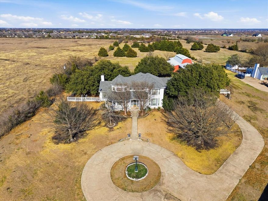 NO HOA — Bring your horses, cows ,chickens & all your autos & toys!  50X54 barn-shop, AC Heated She Shed, Generator, Gazebo, ponds on 10 plus acres! This stunning Victorian Country Manor with foam insulation for efficiency sits on 10+ rolling, treed acres with ponds, offering privacy, beauty, & true ranch-style living just minutes from Lake Ray Hubbard & the sought-after communities of Heath & Rockwall. Long extended drive welcomes you to the private estate with circle drive providing ample parking for your guest & leads to an estate home featuring a veranda wraparound porch perfect for relaxing & enjoying peaceful country views. Inside, soaring living room ceilings, impressive staircase & abundant custom built-ins create a stunning yet warm atmosphere. The home features a chef’s dream kitchen, dining room, & a bright breakfast area highlighted by a unique rotunda ceiling. The tranquil Florida Room overlooks the estate, providing the perfect space to unwind. The dedicated office includes a full wall of built-ins & is ideal for the working professional. The spacious primary suite offers a luxurious en-suite bath & oversized closet space. Three additional bedrooms, each with its own full bath, make this home ideal for large families or guest. Designed for comfort & efficiency, the home features a full-home Generac generator, solar power system, foam insulation, & low utility costs — ready for every season. Enjoy peaceful country living while remaining close to excellent schools, shopping, dining & beautiful Lake Ray Hubbard. This well-loved estate -ranch is ready to welcome its new owners. Town & Country living at its best!