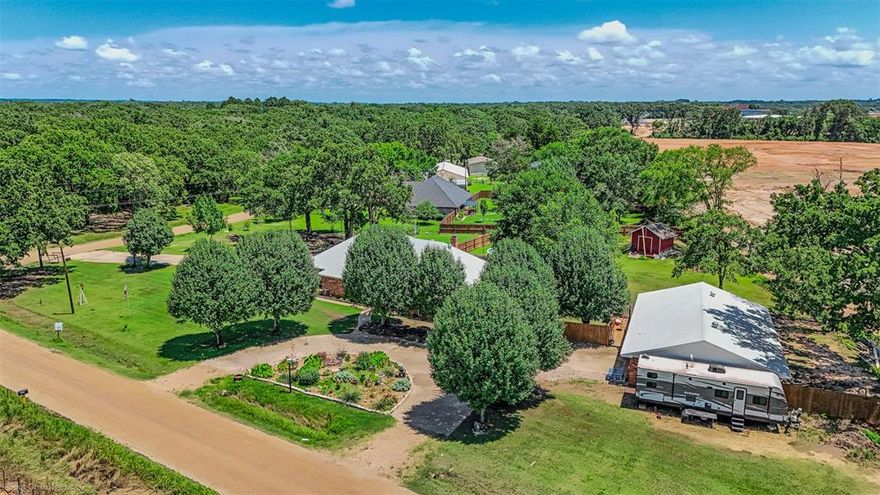 Discover the captivating country charm of this exceptional multi-generational property nestled just outside Canton, TX. Perfectly positioned on a spacious 1.22-acre corner lot, this unique offering boasts two separate brick homes and two RV hook-up sites. Whether you're seeking a family compound or rental income, this property provides endless possibilities.
With 2,190 sqft of living space, the main home’s thoughtfully designed split bedroom layout ensures privacy and optimal space for entertaining. A circle drive and inviting covered front porch lead you inside to a formal foyer and dining room. The expansive living room is a haven of natural light and coziness with its charming wood-burning fireplace. A sizable eat-in kitchen comes equipped with stainless steel appliances and ample prep space. 
A fully-functional home in its own right, the 1,050 sqft guest house includes a kitchen, a spacious laundry room, a split-bedroom floor plan, and a large full bathroom. Partially converting the attached garage added an 8x10 bonus room for extra flexibility.
Recent updates showcase the meticulous care given to the property, including new roofing, windows, HVAC, water heaters, and garage opener. Outdoors, relax amid vividly landscaped flower gardens and lush shade trees, or entertain and unwind by the pool, deck, and pergola. Additional amenities include a new wood privacy fence, extended concrete patio, French drains, and an advanced aerobic sprinkler system.
Situated just outside city limits yet conveniently close to amenities and highly-rated Canton ISD schools, this property offers scenic views of rolling pastures and the future Canton HS Agricultural Facility. A separate septic system for the guest house provides potential for easy property subdivision. Tractors, trailers, furniture, and appliances are available for separate purchase. Experience the unparalleled potential and peace this Canton haven provides.