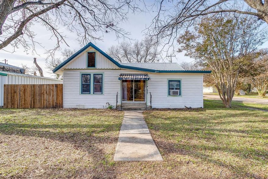 Step into classic small-town Texas living with this well-kept 1950s 2-bed, 1-bath home located just moments from the historic Meridian courthouse square. This Bosque county beauty blends vintage character with everyday comfort, offering an ideal opportunity for a first-time buyer, downsizer, or investor looking to be close to all that downtown Meridian has.

Inside, you’ll find a cozy layout with warm natural light, original mid-century touches, and plenty of potential to make it your own. The kitchen and living areas feel inviting and functional—perfect for simple living or weekend getaways. The primary bedroom features a massive walk in closet!

Outside, the property shines with a detached garage, a spacious carport, and room for projects, storage, or covered parking. The yard is manageable and charming, giving you space to garden, relax, or entertain.

If you’ve been looking for an affordable home with character, convenience, and small-town charm, this is the one.
