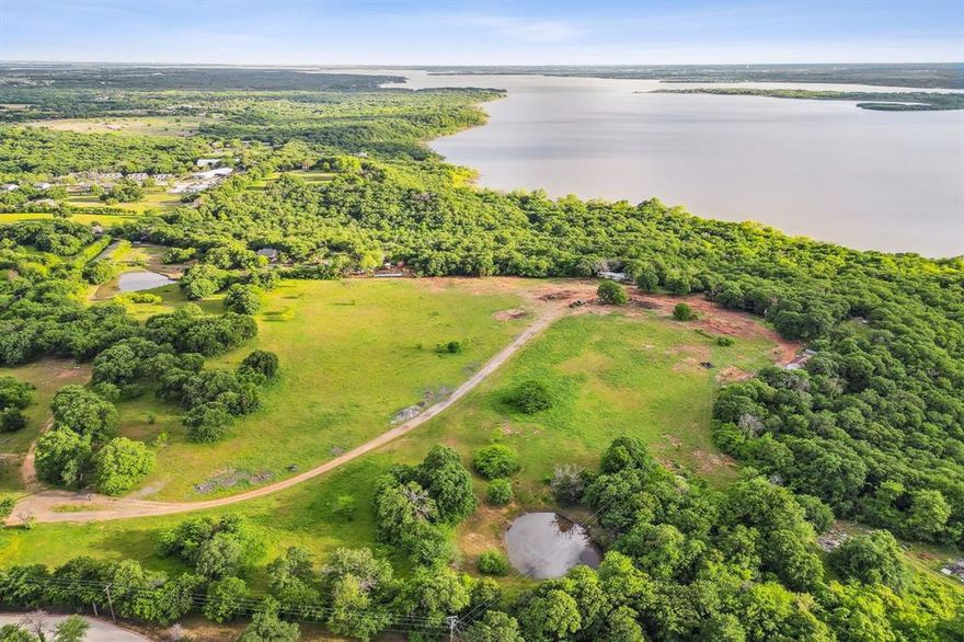 Water views are captivating from this 63 acre rare opportunity to develop along the north shore of Lewisville Lake. Build your dream development with lakeside activity trails. A large portion of the land is cleared and extends out to a lookout point where stunning sunset and lake views abound. An additional approximate 13 acres can be purchased that is in the ETJ and can be directly accessed from highway 380.