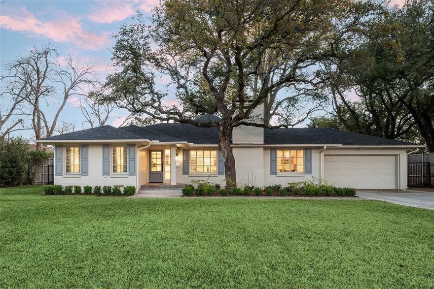 Sparkling and freshly renovated, this stunning home is located in prestigious Preston Hollow on an expansive 100 x 174 lot shaded by multiple mature trees. Fresh interior paint and beautifully sanded and sealed hardwood floors create a subtle yet sophisticated feel throughout the home.
A welcoming fireplace shared between the living and dining rooms creates a warm and inviting space ideal for entertaining guests. The fully renovated kitchen features an expanded island, custom cabinetry with soft-close drawers, stainless steel appliances, and a walk-in pantry. A separate utility room with sink adds additional convenience. Just off the kitchen, a stylish dry bar complete with a wine cooler connects to the spacious family room. This impressive living area features a vaulted ceiling, a second fireplace, and large windows overlooking the expansive backyard and entertainment patio-perfect for gatherings both indoors and out. The large primary suite offers high ceilings and a beautifully updated spa-like bath designed for comfort and relaxation. An intimate exterior courtyard sits between the primary and second bedroom, providing a peaceful outdoor retreat while also offering an excellent opportunity to expand the interior square footage if desired. All three bathrooms have been fully renovated with quality finishes and thoughtful design. Significant recent improvements enhance the home's value and functionality, including updated HVAC, roof, and water heater. Located on a generous lot in one of Dallas' most desirable neighborhoods, this move-in ready Preston Hollow home combines modern updates, timeless style, and exceptional entertaining spaces both inside and out.