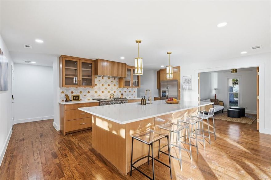 Completely renovated showstopper with true mid-century vibe in a prime North Dallas location within sought-after private school corridor. From the striking exterior to the thoughtfully redesigned interior and resort-style backyard, this home impresses at every turn. No detail was overlooked with all major systems replaced, including new roof, new water and sewer lines, tankless water heater, new electrical panel, and new HVAC. The home features open-concept living and dining plus a versatile flex room perfect for an additional living area, media space, or home office. Now for the highlights—an all-new chef’s kitchen with oversized quartz island, high-end appliances, custom cabinetry, and an expanded walk-in prep pantry with built-in serving and storage space, ideal for entertaining. Beautiful 2¼ oak flooring flows throughout, complemented by curated retro lighting that preserves the home’s mid-century character while delivering modern comfort. The primary suite is a private retreat with spa-inspired design, terrazzo tile, and a large walk-in shower. All 3.5 bathrooms have been completely updated. A thoughtful layout includes a split second suite ideal for guests or multi-generational living. This is not a standard renovation—every space was designed with personality, warmth, and intentional flow.