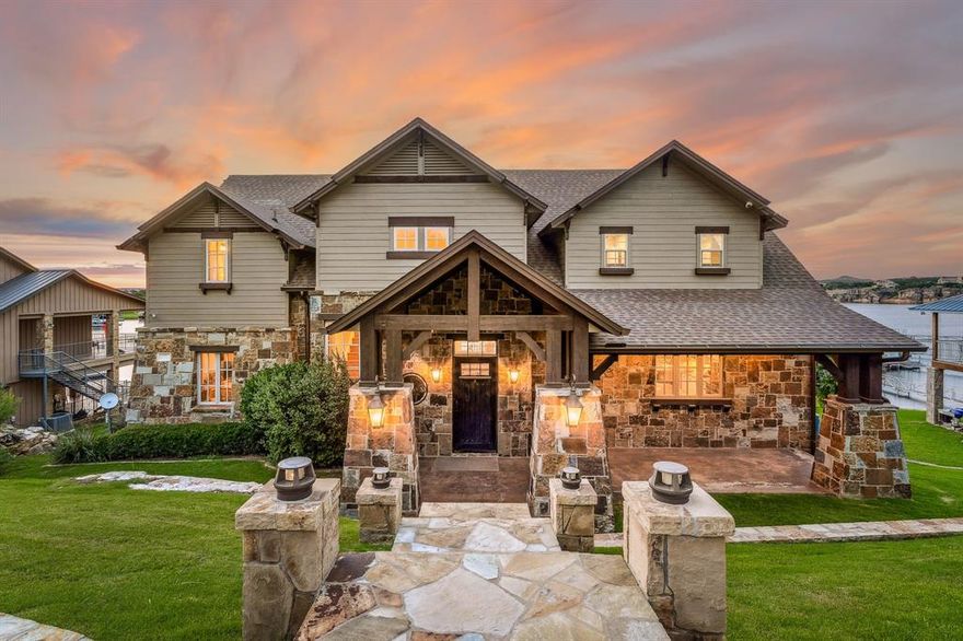 Experience elevated lakefront living in this 6-bedroom, 5.5-bath luxury smart home in Possum Kingdom Lake's prestigious Gaines Bend community. With 5,311 sq ft across three beautifully designed levels, this fully furnished home blends comfort, style, and entertainment. The gourmet kitchen features premium appliances, dual islands, and a walk-in pantry, perfect for hosting gatherings. Two spacious living rooms and two cozy fireplaces inside offer inviting spaces to relax while enjoying panoramic lake views. The second living area includes a full-size kitchen with bar top seating and an additional walk-in pantry, ideal for extended family or guests. Balconies on the top two stories deliver breathtaking lake vistas—perfect for morning coffee or evening sunsets. Outdoor amenities include a 2-story boat dock with 2 boat slips and a seadoo slip, providing effortless lake access. The property also offers 2-car covered parking and a storage shed for convenience. Smart home technology allows seamless control of lighting, climate, and security whether you’re home or away. Located within the private, gated Gaines Bend neighborhood, this property offers peace and privacy while still being minutes from marinas, dining, and year-round recreation. Whether you're seeking a full-time residence, weekend retreat, or income-producing rental, this exceptional lakefront home delivers an unmatched Possum Kingdom Lake lifestyle. Properties of this quality are rarely available—schedule your private showing today.