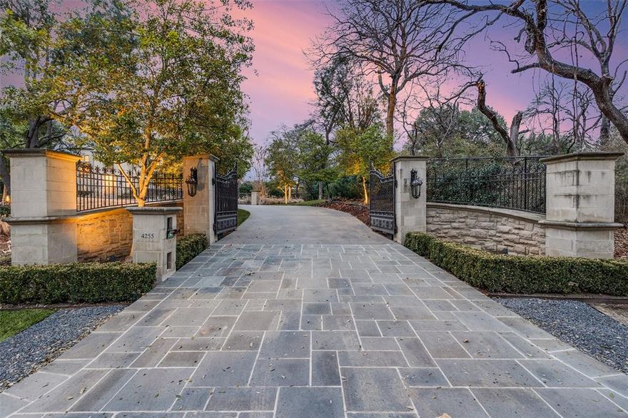 This Private French Estate with tennis court is nestled behind secure gates on two beautifully landscaped acres, offering timeless architecture, extraordinary privacy, & extensive recent upgrades. Built by Cy Barcus and designed by renowned architect Wilson Fuqua, the 11,056-square-foot residence showcases impeccable craftsmanship, grand scale, & sophisticated living. A dramatic foyer with a sweeping staircase opens to elegant formal living & dining spaces, refined archways, & a gracious family room featuring a fireplace, bar, & wine cellar. The fully renovated gourmet kitchen is equipped with new custom cabinetry, countertops, Wolf & Sub-Zero appliances, oversized island, double ovens, built-in refrigeration, & a butler’s pantry. The oversized primary suite is secluded on the main level & includes a sitting area with blackout shades, fireplace, expansive his-and-hers closets, & a completely remodeled spa bath with designer finishes. Upstairs offers four spacious ensuite bedrooms plus a large game room & kitchen. Designed for effortless entertaining, the home features exceptional indoor-outdoor flow to a resort-style backyard with pool, outdoor kitchen, covered living areas, cabana, & tennis court. Extensive Improvements & Features Include: RTI smart home system; Lutron lighting; designer tile by Ann Sacks, Walker Zanger, & Artistic Tile; updated bar, family room, study, dining room (with hand-painted Allan Knight wallpaper); new mini kitchen upstairs; new water filtration system, thermostats, sewer line, chimney cap; three-car garage with EV charging in each bay; Complete wood, iron, & chain-link perimeter fencing for maximum security; Expanded drive & improved motor court & porte cochère; Renovated fountain with bluestone surround & new pool walkway, & MORE! A rare opportunity to own an updated, architecturally significant estate offering privacy, scale, & luxury amenities in a premier Dallas location. Conveniently located near the private school corridor!