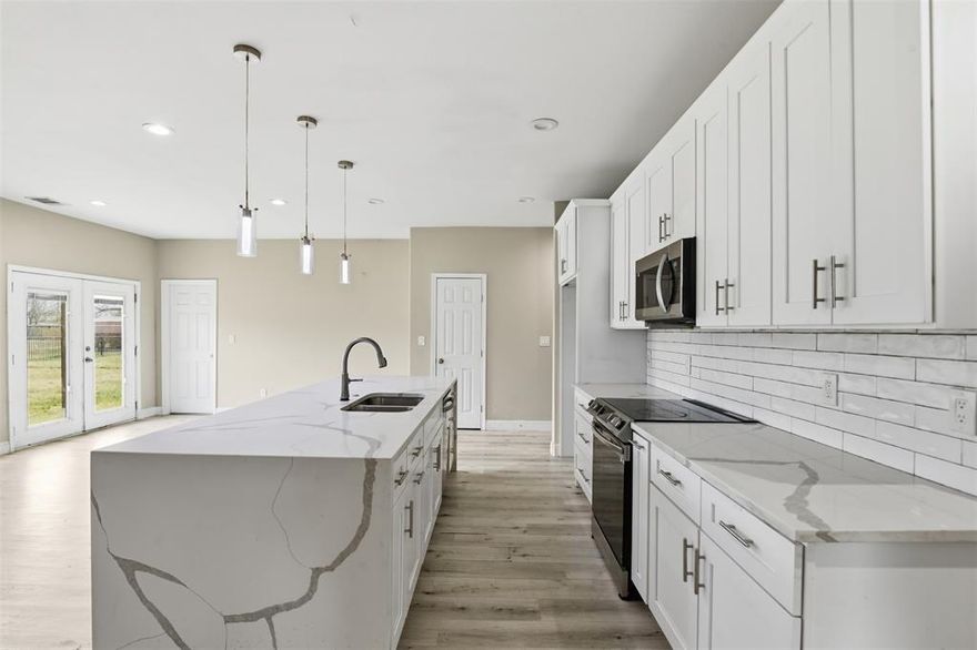 Recent REFRESH includes interior deep clean, wall & trim paint, and professionally cleaned carpets. **Motivated seller—bring all offers** Situated on an oversized lot, this 4-bedroom, 3-bath home is offered at an exceptional value and showcases a flexible layout designed to fit today’s lifestyle and offers great potential for the right buyer. The thoughtfully designed floor plan provides comfortable living spaces ideal for both everyday living and entertaining, while allowing room for some TLC and personal touches. The kitchen is a true centerpiece, featuring a striking waterfall island, built-in storage, walk-in pantry, coordinating quartz countertops, and generous soft-close cabinetry, along with sleek stainless-steel appliances.
The primary suite is privately situated away from the secondary bedrooms, creating a peaceful and inviting retreat. It features a spa-inspired ensuite with dual vanities, a freestanding soaking tub, and a frameless glass shower accented with custom finishes. Large windows overlook the tranquil, expansive backyard, providing a relaxing space to unwind.