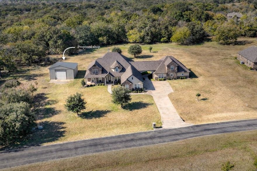 Come tour this beautiful home in person — you won’t want to miss it! TWO exceptional homes. ONE stunning 2.5-acre homesite. Experience luxurious multi-generational living in this impeccably crafted estate within the gated Boling Ranch Estates. Set on 2.5+  acres with a private back yard, this one-of-a-kind property boasts two independent residences. Offering the perfect blend of independence & connection—ideal for extended family, adult children, guests or in-laws. Price includes a to be built shop, after closing - approx 30x40 with 10' roll up door concrete slab & metal weld up structure. Customize the shop size, doors, windows, features for additional cost. Cost of shop will be financed in your purchase! Now let's walk you thru the inside! The main residence features 4 beds, 4.5 baths in over 3600 sqft of refined living space. The inviting living room showcases built-ins, floor-to-ceiling stone fireplace & expansive windows with backyard views. The chef-sized kitchen features double ovens, abundant cabinetry, prep island with adjoining breakfast nook, butlers pantry & formal dining space. The luxurious primary suite includes a sitting area with French doors to the back porch; the ensuite offers dual sinks, soaking tub, generous walk-in closet & large dual-head walk-in shower. Upstairs is a spacious game room with half bath, ideal for entertaining. Additional highlights include ensuite baths for each secondary bedroom, laundry chute, BRAND new roof, 2022 HVAC systems. Oh yea, THE SECOND HOUSE! …Offering nearly 2000 sqft 3 beds, 2.5 baths, formal dining room, full laundry room & dedicated office designed for flexible use, work-from-home or private living quarters. Outdoor amenities include expansive covered porches & a stone fire-pit, creating ideal spaces for gatherings & year-round enjoyment. So much to offer your family in this custom built, one & only multi-generational property - so bring the WHOLE family! Txt keyword TEXAS5 to 88000 for Virtual Tours & More!