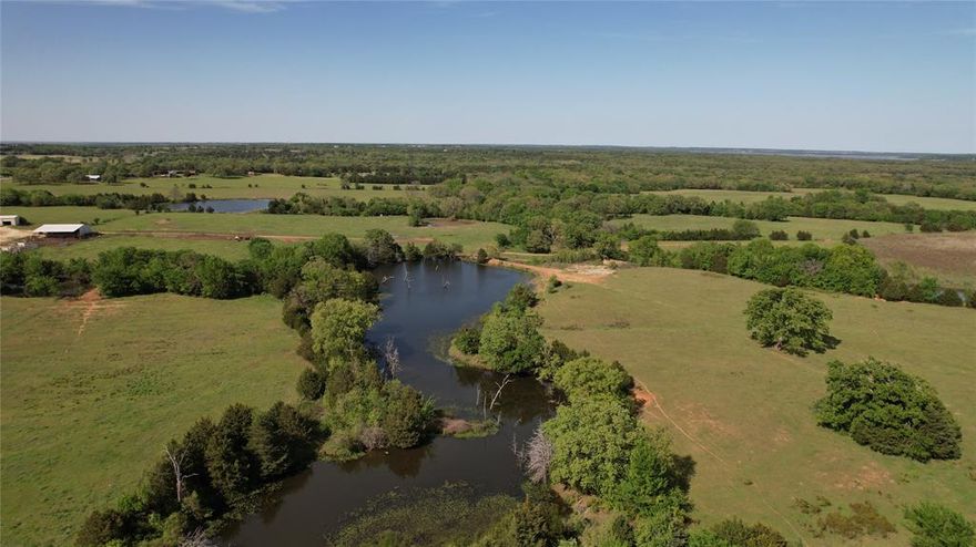 Ripe for investment opportunities, this 197+ acre ranch property is a dream for those seeking their own piece of Texas paradise. Adjacent to Corps of Engineers land and near Lake Texoma, the ranch offers rolling terrain with varied topography, spectacular panoramic views, plenty of mature trees scattered throughout, pastures for grazing cattle, wooded areas, and multiple tanks stocked with catfish and bass. The location is ideal. Access to Lake Texoma can be found minutes away at Juniper Point ramp and Walnut Creek Resort. The property is also near the coming soon Hard Rock Hotel and Residences as well as the newly planned Margaritaville resort in Denison. The property has a quaint 4-bedroom, 2-bathroom country home at the front that offers a spacious living area, an open eat-in kitchen with a separate dining area, four large bedrooms including one with an en-suite, and a covered front and back patio. Outside, you'll find two outbuildings totaling 3,200 sqft and 2,800 sqft of carport space. Only an hour from the DFW metroplex and minutes from shopping and entertainment, this property truly is a gem!
