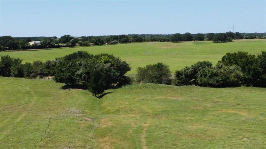 Highly desirable 109-acre ranch in Parker County, ideal for cattle operations and hay production. The property features good fencing, mature trees, and open, usable pasture well suited for grazing, baling, and rotational use. This property offers ample pasture suitable for cattle operations, with the ability to support a functional grazing program under proper management. The property is currently AG-exempt (buyer to verify continuation) and also provides excellent habitat for wildlife and hunting opportunities. A 100-year floodplain and a utility easement are present; however, both are easily workable and allow ample room to build a ranch home, barndominium, barns, or additional improvements while maintaining efficient pasture use. Bring your cattle, put the land to work, and enjoy the long-term value of owning quality agricultural acreage in Parker County. Large, productive tracts like this are increasingly rare.
