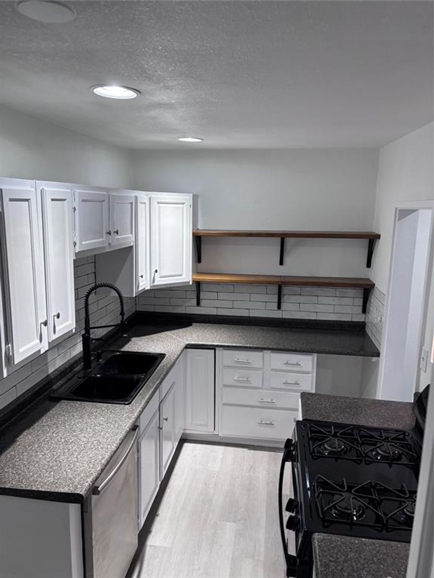 Stunning Remodeled 1-Bed, 1-Bath Condo – Move-In Ready!Welcome to a beautifully updated first-floor condo in Fort
Worth’s desirable Spanish Gardens community. This bright 806 sq ft home has been completely refreshed with modern
finishes throughout.Inside you’ll find fresh neutral paint, wide-plank gray luxury vinyl plank flooring, and recessed
lighting for a clean, open feel. The spacious living room offers a large window overlooking peaceful green space and
trees.The fully remodeled kitchen shines with white shaker cabinets, open shelving, sleek black granite counters, a
black under-mount sink with gooseneck faucet, and modern black appliances. The light-filled primary bedroom includes
ample closet space. The updated full bath features elegant marble-look in shower, a contemporary vanity, and
upgraded fixtures.Additional highlights: • Multiple deep closets with built-in shelving • In-unit laundry area • Low-
maintenance condo livingPerfect for first-time buyers, down sizers, or investors. Turnkey and move-in ready — just
bring your furniture!Priced to sell and showing beautifully. Schedule your private tour today! Spanish Gardens
Condominiums Fort Worth, TX 1 Bed 1 Bath 806 Sq Ft Fully Remodeled & Updated Unit next door also available #705