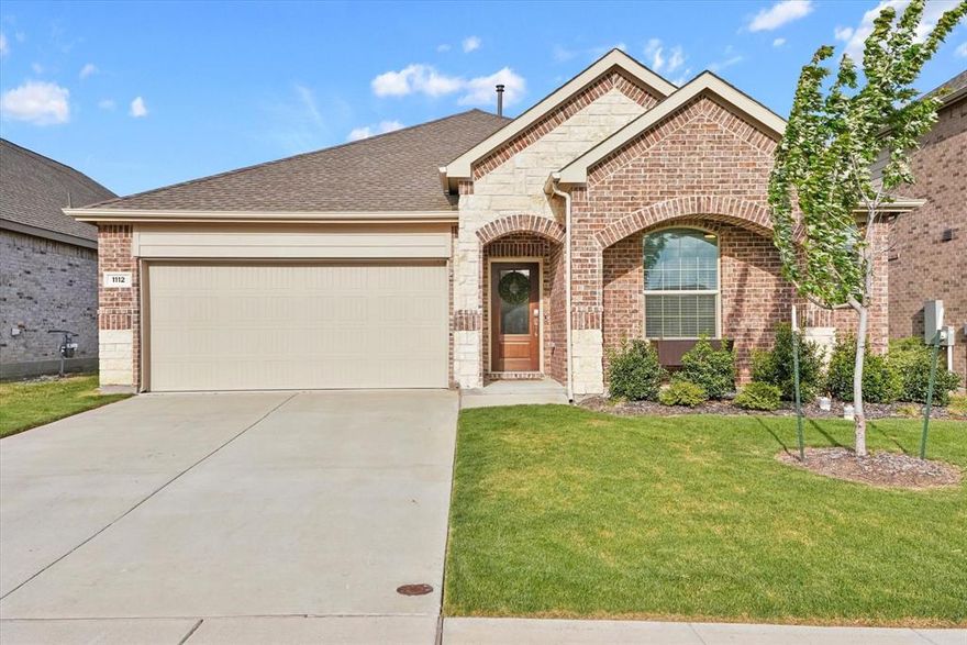 Welcome Home to 1112 Rumble Dr in Rockwall! Discover the charm of like-new living in a wonderful neighborhood. This charming 4-bedroom, 2-bath home over 2,000 square feet of thoughtfully designed space where modern craftsmanship meets everyday comfort.

Step inside and you'll immediately notice the beautiful laminate flooring flowing throughout an open floor plan that feels both spacious and inviting. Custom character details elevate the warmth of this home. The eat-in kitchen features quartz counters, an island, a gas range, and stainless steel appliances.

The primary suite is your private retreat, complete with an en-suite bath featuring a dual vanity and walk-in shower, plus a spacious walk-in closet. Three additional bedrooms provide plenty of room for family, guests, or a dedicated home office.

Outside, a covered patio overlooks the private backyard. A convenient storage shed adds practical functionality. You'll love the proximity to Robert Smith Family Park, just minutes away on CD Boren Parkway, offering green space and recreation.

Nestled in a welcoming residential community, this Rockwall gem delivers quality construction and lifestyle convenience. Schedule your showing today before this one slips away!