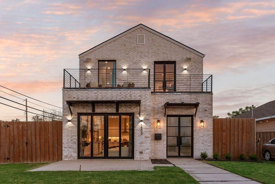 Sleek & sophisticated 5 bedroom, 3.5 bathroom modern home in Trinity Groves. Located just a mile past the iconic Margaret Hunt Hill Bridge, this home places you moments from downtown Dallas and access to dining, nightlife, and city energy. Built in 2022 this home has it all. Enter into a huge open concept living space that flows effortlessly from living to dining to kitchen. Sweeping picture windows with bold black trim bring tons of natural light into the home. The dining area includes a built in buffet or dry bar with dual drink fridge spaces. The chef’s kitchen features a massive quartz island with seating for four, modern shaker cabinets, and built in stainless appliances including 5 burner gas cooktop. This light-filled space offers both style and functionality with ample storage and stunning finishes. A guest suite is tucked behind the kitchen on the first floor with a large walk in closet and private en suite bath with walk in shower. The oversized utility room is a dream with wall to wall cabinets including shoe storage, counter space for folding laundry and laundry sink. Gorgeous luxury vinyl plank floors throughout the living areas that ascend the staircase to the second floor where you will find 4 bedrooms. The primary suite features 2 closets, a peaceful rooftop terrace which makes the perfect outdoor retreat for the owners and a spa like ensuite bath with dual sinks, standing shower and free standing acrylic soaking tub. The huge 5th bedroom also boasts its’ own rooftop terrace as well as large walk in closet and tall vaulted ceiling. This space would also make an excellent second living space or lounge area. Driveway and side yards are fully enclosed with a tall board on board fence with electric drive way gate, so pets and kids can have the run of the place. The side patio can also serve as additional parking with direct access to the kitchen.