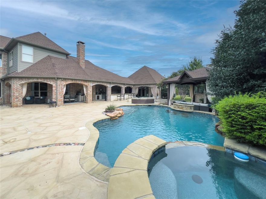 A rare find in the prestigious gated community of Starwood, this stunning estate features a private guest house overlooking the pool — a perfect retreat for extended family or guests. The guest residence offers its own garage, full kitchen, living area, bedroom, bath, and laundry, providing complete independence while remaining connected to the heart of the property.

The main home is beautifully designed with 4 bedrooms, 3.5 baths, and exceptional attention to detail throughout. The first floor includes the luxurious master suite, a private study for working from home, a media room ideal for family movie nights, and a spacious open-concept living area that blends seamlessly with the designer chef’s kitchen. Outfitted with premium appliances, custom cabinetry, and an expansive island, the kitchen serves as the perfect gathering place for family and friends.  Upstairs there are three additional bedrooms with en-suite bathrooms and two living areas.

Step outside to experience resort-style living in your own backyard. The pool and spa are surrounded by mature trees, lush landscaping, and multiple outdoor living spaces — including a covered cabana, built-in outdoor kitchen, and cozy fire pit area. The large grassy yard provides plenty of space for play, entertaining, or quiet relaxation under the Texas sky.

Inside and out, this home balances luxury with livability, offering both grand entertaining spaces and intimate areas for everyday comfort. Located in one of Frisco’s most sought-after communities, residents enjoy gated security, walking trails, tennis, parks, and close proximity to shopping, dining, and top-rated Frisco ISD schools.

This is more than a home — it’s a lifestyle.