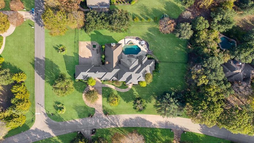 $20K IN SELLER CONCESSIONS WITH ACCEPTABLE OFFER! Experience refined luxury living in one of Fairview’s premier estate neighborhoods. Set on over an acre of manicured grounds, this extraordinary custom home is a rare offering—timeless architecture blended with partial renovation completed in August 2025, delivering a truly turnkey and elevated estate experience. Inside, the home unfolds with newly refinished, sanded, and stained oak hardwood floors, fresh Alabaster paint throughout, and replaced carpet in all bedrooms, closets, and the media room. Every detail has been thoughtfully elevated—laundry, bar, and primary bath cabinetry freshly painted with new hardware, new door hardware including coded exterior entries, new light switches, and sophisticated, design-forward chandeliers in all common spaces and the primary suite. The kitchen is an entertainer’s dream, appointed with Z-Line professional appliances and a built-in Frigidaire Professional refrigerator_freezer, complemented by whole-home in-ceiling audio wiring for seamless living and hosting. Outdoors, your private sanctuary awaits. The resort-style backyard features a sparkling, beautifully designed pool, expansive covered patio with a cozy fireplace and a full culinary setup including a built-in flat-iron grill, outdoor ice maker and refrigerator, and a built-in Green Egg grill—perfect for gatherings, summer evenings, and effortless entertaining. The exterior shines with-recently replaced up-lighting, front and rear fixtures, and freshly painted exterior doors and trim. Additional upgrades include a ridge-vent system for proper ventilation, professionally epoxy-coated garage floors, security fence panel access, and a Ring doorbell camera. This home is not simply updated—it's been reimagined, refined, and meticulously curated for the next owner who desires luxury, privacy, and modern ease in one of Fairview’s most coveted communities. A true rare gem—inside and out.