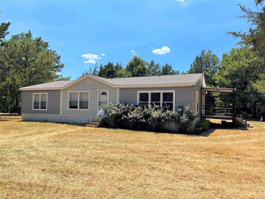 Here it is! The private piece of land so many are looking for in Freestone Co!  This approximately 19 acres has WILDLIFE and a practice range too! The 2012 3 bed, 2 bath manufactured home is a split floor plan with nice sized eat in kitchen with bar island. The master bath has double vanities, jetted tub, separate shower, and walk in closet. A handy desk is in the hall between bedrms 2 & 3 and there is a hall bath with tub & shower combo.  The washer, dryer, and refrigerator are included, Spacious combination mudrm & laundry rm, full size washer & dryer area, room for a freezer, and an office area. The large shade tree area has power access from the house for lighting. Partially Fenced.  Do you need a shop or storage space? This property has both.  An 18 x 26 metal 3 sided barn, and a storage building complete this great country package!