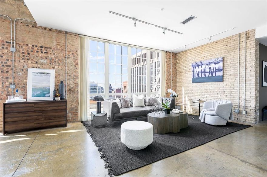 2 story Penthouse loft with soaring 20ft ceilings. Corner unit with tons of natural light. Western and Southern views with 2 outdoor patios. Large master and full bath on 2nd level with large walk-in closet. Beautiful exposed brick throughout. Full size washer and dryer included. Building has gym and rooftop pool. Owner pays water and trash.