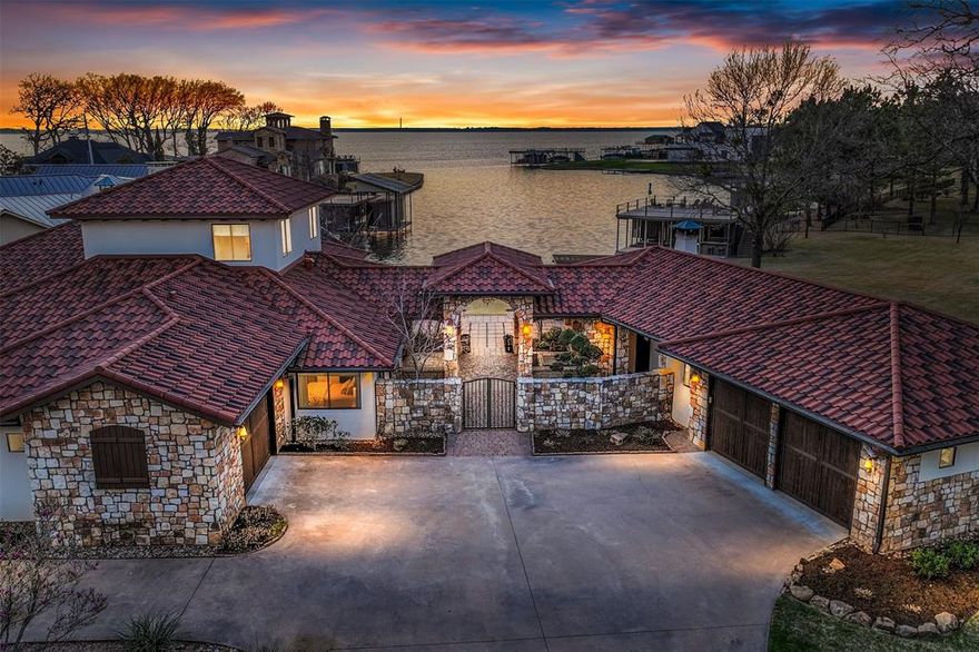Experience the epitome of lakeside living in this Stunning Mediterranean-style lake home! Sprawling across two expansive lots & boasting over 275 feet of waterfront, this property offers expansive outdoor entertaining spaces & provides an exclusive waterfront lifestyle. The main residence consists of 4 bedrooms & 4.5 baths showcasing a rustic contemporary design, with meticulous attention given to every detail. As you step inside, the hand-scraped wood flooring guides you through an open-concept layout, creating a warm & inviting atmosphere. The living area features a gas fireplace & a wall of windows, offering breathtaking views of the lake. The gourmet kitchen, is a chefs dream adorned with a 4-burner gas range featuring double ovens, a griddle, & a grill. The kitchen seamlessly integrates with the dining area, providing ample space for entertaining large groups. Additionally, a separate, well appointed, 1-bedroom, 1-bath casita provides additional accommodations for guests.