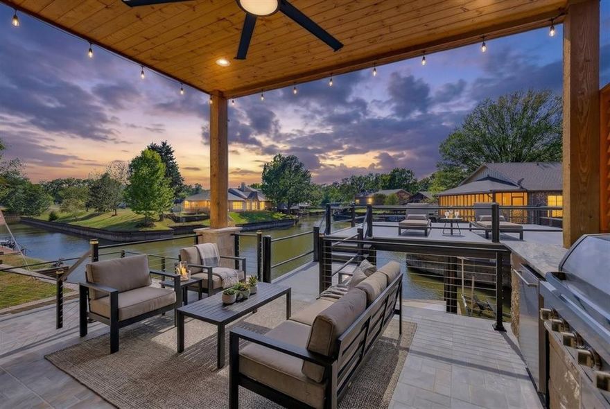 This is where lake life starts to feel exactly the way you imagined it would. Peaceful water. Stunning sunsets. And room to truly unwind.
Tucked away on a protected cove away from the busy windy open water, yet still offering beautiful lake views this custom stone smart home was designed for both relaxation and entertaining. Inside, the open-concept layout draws your eye straight to the water. The chef-inspired kitchen features gas cooking indoors and out, creating the perfect space for gathering with family and friends. The primary suite is a true retreat, complete with a spa-like bath, soaking tub, steam sauna shower, custom closet, and private deck to take in the view. Step outside and enjoy a premium Wahoo aluminum boathouse with party deck, lift, and easy catwalk access—ideal for long lake days and effortless evenings. Low-maintenance features like a 50-year Malarkey roof and lake-fed irrigation give you more time to enjoy the lifestyle, while smart home technology adds comfort and convenience. With flexible space for a home office or fourth bedroom and short-term rental potential, this property works for full-time living, weekend escapes, or investment. Some homes look great online This one is meant to be experienced in person. Schedule your private showing and see it for yourself.