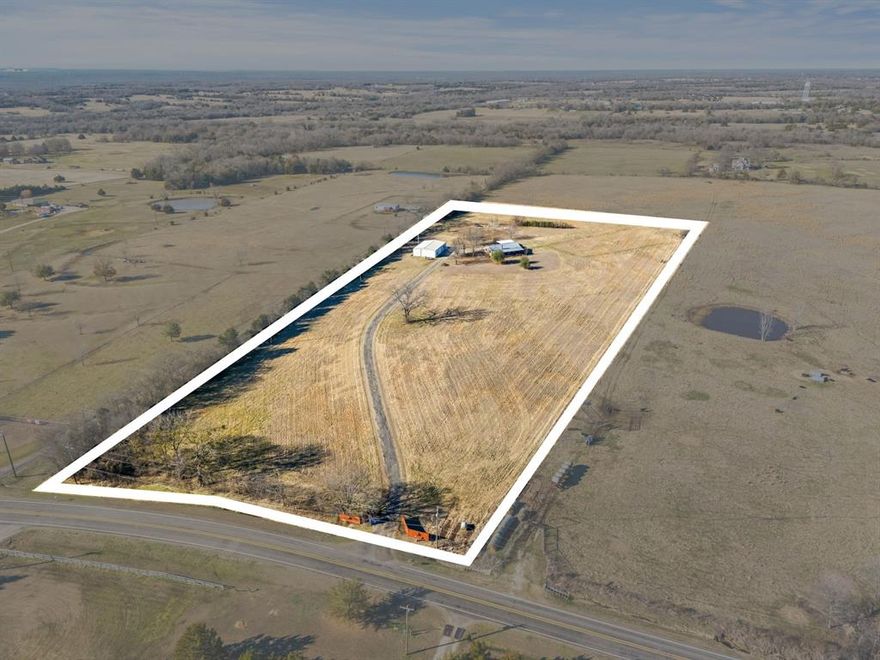 Set on 10.31 acres in Lone Oak and located in highly rated Lone Oak ISD, this property offers space, versatility, and room to grow. The land currently carries an agricultural exemption and includes a single-story main residence, carport, expansive shop, and a fully updated guest apartment—ideal for extended stays for guests, or a home-based business.  A spacious front porch invites you to enjoy quiet mornings and wide views of the surrounding acreage. Inside, hard-surface flooring throughout provides durability and easy maintenance. The kitchen is equipped with stainless steel appliances, a smooth-top range, and ample cabinetry, while the living area features a corner wood-burning stove that adds warmth and character during cooler months.  Recent improvements enhance both value and peace of mind, including two new HVAC systems (2022), a new water heater (2024), shop garage door openers (2022), and an electronic vehicle charging outlet (2024). An RV hookup adds additional flexibility for guests or travel needs.  The 40x60 shop offers two roll-up doors, epoxy flooring, and is equipped with electricity and water—making it well suited for equipment, storage, projects, or an indoor sports area. Attached is an approximately 600 sq ft guest apartment with its own kitchen, living area, bedroom, bathroom, utility space, and a private patio, allowing for comfortable accommodations or dedicated functional space separate from the main home.  With over 10 acres of usable, open land, there’s ample space for animals, gardening, recreation, or simply enjoying the privacy and pace of country living. Zoned to highly sought after Lone Oak ISD, Lone Oak High School has recently completed a redesign that added enhanced athletic facilities, science and health labs, a band hall, concession and dining areas, and an ag barn with instructional space. This Lone Oak property combines acreage, updates, and opportunity in a peaceful setting. Schedule your showing to explore all it has to offer.