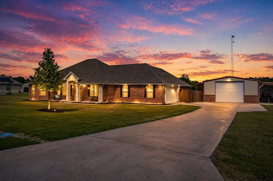 Set outside the city limits of Farmersville, this custom-built home offers space, flexibility, and functionality. With over 2,800 square feet of combined living space between the main home and private guest quarters, this property delivers a setup that is both practical and hard to replicate. Inside the main home, you’ll find 4 spacious bedrooms with a split-bedroom layout that gives the primary suite added privacy away from the secondary bedrooms. The open living and kitchen floorplan was designed for both everyday living and entertaining, featuring double ovens, massive counter space, abundant cabinetry, and storage that truly works for a busy household. Spray foam insulation adds energy efficiency, while the whole-home water softener system, oversized attached garage, and utility sink bring practical convenience. The backyard is where this property truly shines. The oversized covered back patio spans 581 square feet and feels like a true extension of the home, with dedicated areas for dining, relaxing, and hosting. Whether it’s family gatherings, game days, or quiet evenings outside, this space was built to be enjoyed.
The detached 30x40 shop adds even more versatility with 540 square feet of enclosed shop space, plus a 520 square foot attached carport that is perfect for boats, tractors, additional vehicles, trailers, or equipment storage. Attached to the shop, the private guest quarters offer 660 square feet with 2 bedrooms, 1 full bath, a living area, and kitchenette. Ideal for multigenerational living, guests, a home office, business setup, or potential income-producing use, this space adds tremendous value and flexibility. A 96 square foot covered porch completes the guest quarters, creating a private and functional setup separate from the main home. This is the kind of property that gives you options, privacy, and room to grow, all while enjoying the freedom of country living just minutes from town.