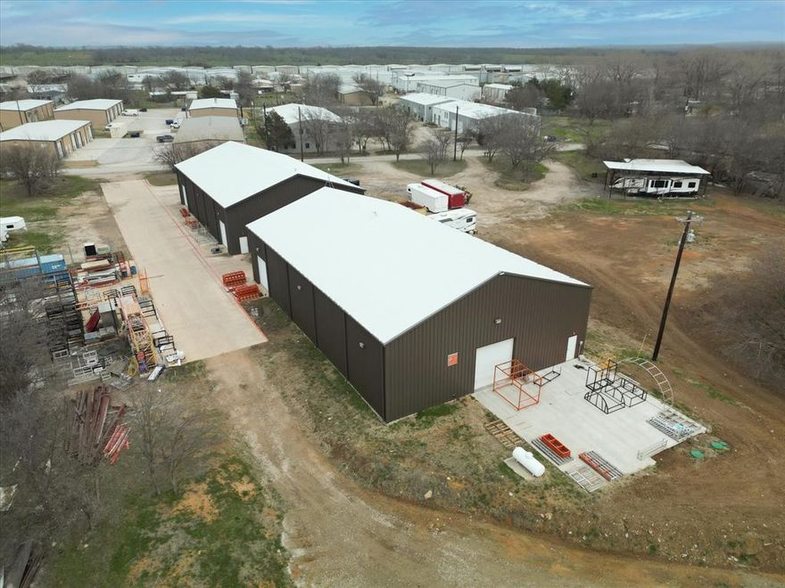 Two ±6000 SF fabrication buildings with 3 phase electric, septic, water, insulated and overhead lighting. Building furthest from road has a woman's and a man's bathroom with office. Building near road has stub out for bathroom, simply needs connection to toilet. Both buildings have extra tall side walls near 24'. Buildings rest on 1.7 acres with ample parking. Lot is directly accessed of Cleveland Gibbs Rd. which is being improved in 2025.