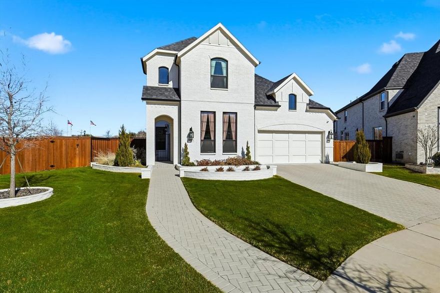 The ideal blend of modern comfort with timeless elegance awaits you at this immaculate southwest-facing two story home on a super-sized lot in The Grove Frisco. Beautiful painted brick exterior gives way to a courtyard entry before reaching the front door, a truly unique entry experience. Modern double entry doors give way to a dramatic Foyer and curved stair case. The upgraded engineered wood flooring is found throughout the home, in every living space except baths, Laundry Room  and Exercise Room. No carpet! Formal Dining located off the Foyer can be used as a Study for maximum flexibility. Dramatic Kitchen with Calacatta Gold counters and Full backsplash, tall ceilings and stacked glass upper cabinets make an immediate impression. Full KitchenAid-equipped with cooktop, double ovens, microwave, integrated refrigerator and wine refrigerator! Wine storage, pot filler and many more upgrades as well. Kitchen opens to dramatic, light-filled Family Room with linear fireplace and fully-tiled surround. Upgrades continue at the rear of the home features and Extended Covered Patio, Primary Bedroom with vaulted ceiling and Sitting Area. Luxurious Primary Bath features extended vanities, freestanding tub, dramatic tiled shower with rain head and ample walk-in closet space. Guest Bedroom down with En Suite bath are located at front of home. Laundry Room leads to Exercise Room with rubber flooring. This space can flex as a Study or Media Room. Upstairs features upgraded wood flooring in every room! Game Room with wet bar and storage room, Play Room, 2 Bedrooms and 2 Baths round out the program for the second floor. Come see for yourself what makes this home so unique and sophisticated! Other features include epoxy garage floors and whole house water filtration. The Grove Frisco is a 735ac planned community with Orchard House amenity center, two pools, a lifestyle Director, extensive green spaces and walking trails. All located within the highly acclaimed Frisco ISD.