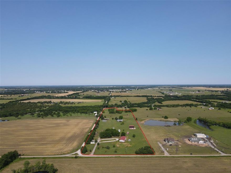 Investors and developers, here you go. This 15 plus acre property has over 1700 feet of road frontage on CR 4855 and 350 feet on 4870 making it very easy to divide into 1 to 2 acre lots. The land has scattered pecan trees and a small pond on the west end as well as 2 large covered parking spaces for RV's or equipment. There is 3 bed 2 bath doublewide mobile home on the east end of the property that has good bones and with some cosmetic work could make a nice home while you build your dream home.